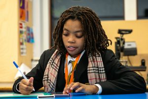 young girl doing studying in learning zone homework club